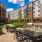 a courtyard with grills, tables and chairs