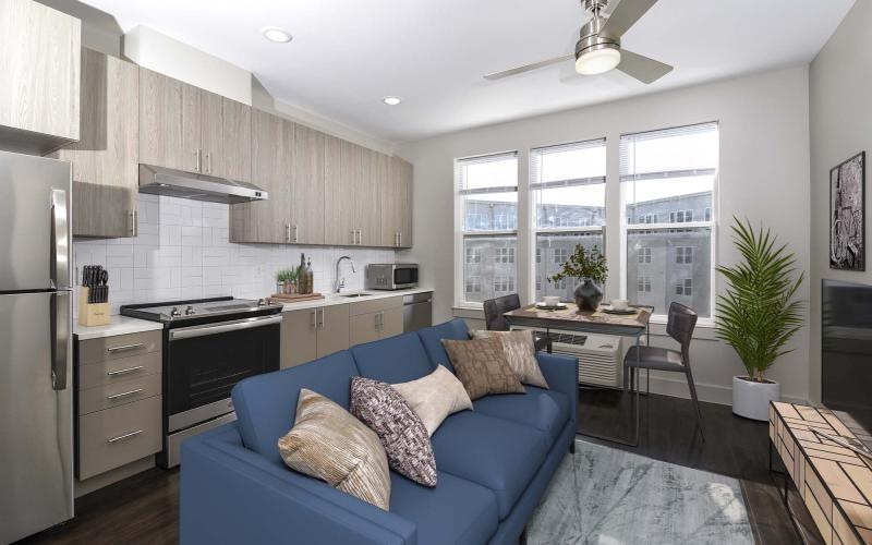 Wide open living areas perfect for entertaining a kitchen and a living room with a blue couch