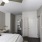 a bedroom with a bed and a fan