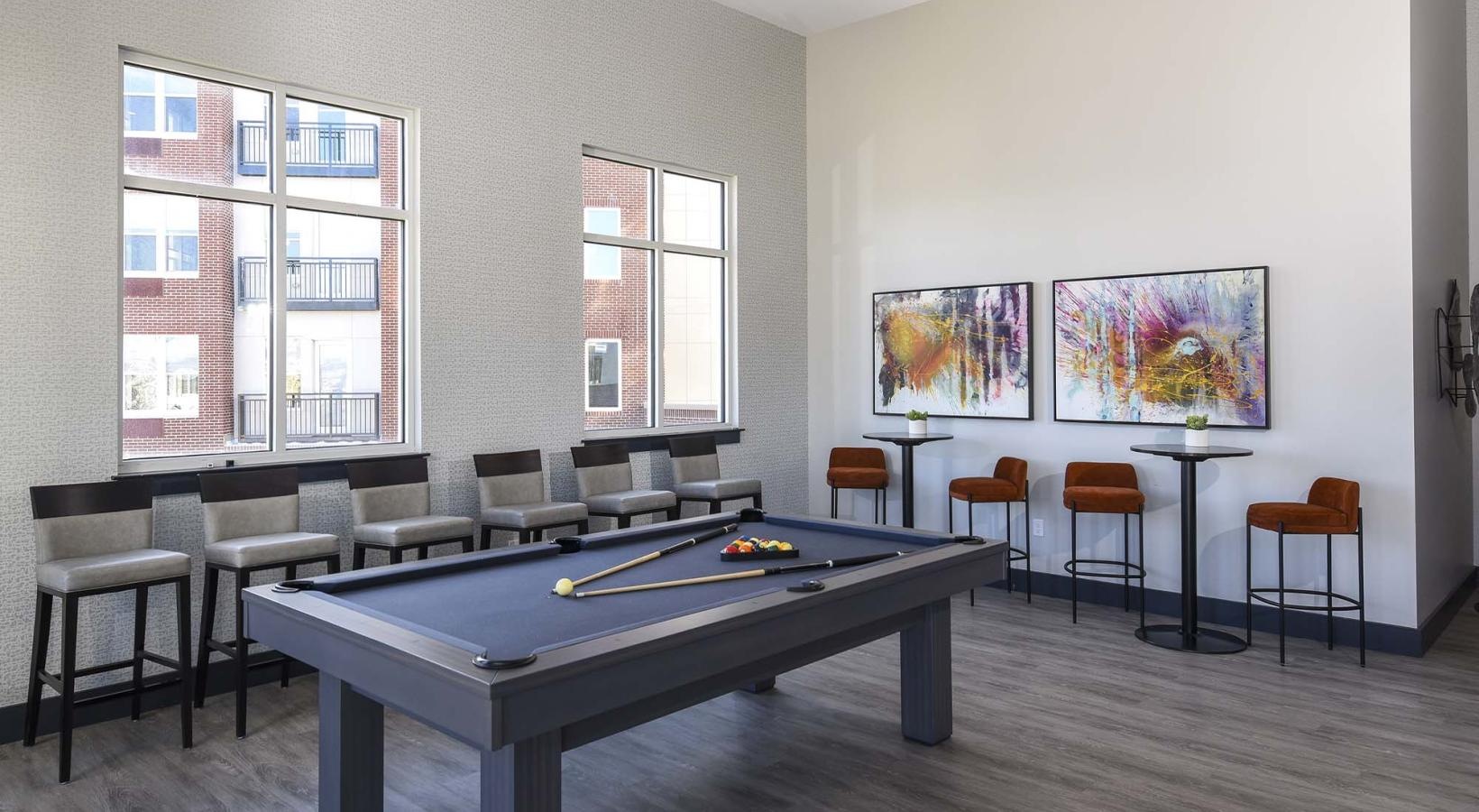 Access to resident-only features a clubroom with a pool table and chairs