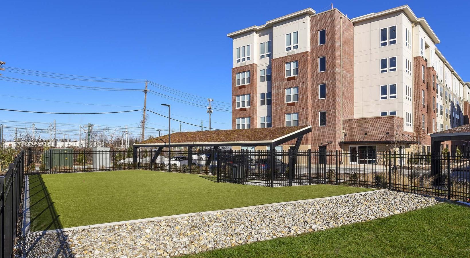 Cutting-edge amenities at your fingertips a small park area in front of a building