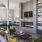 a clubroom with a fireplace, a couch, tables and chairs