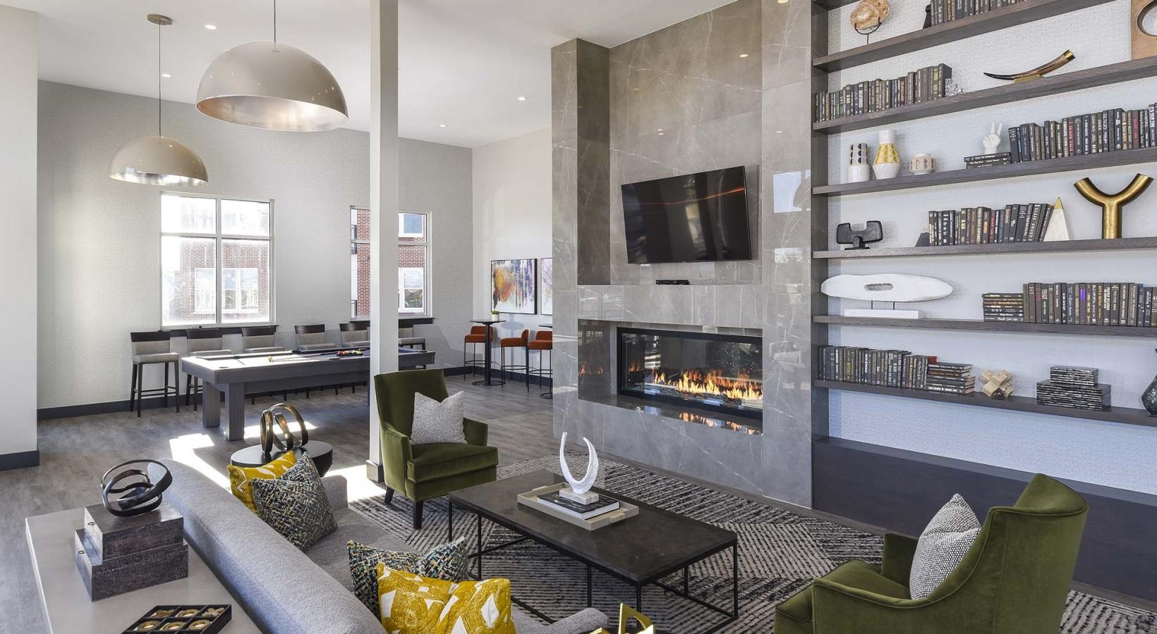 Everything within reach a clubroom with a fireplace, a couch, tables and chairs