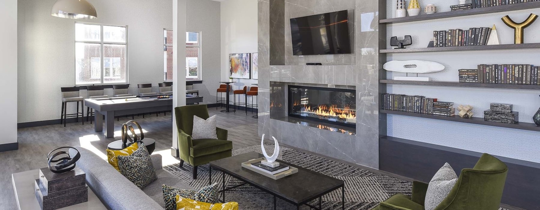 Everything within reach a clubroom with a fireplace, a couch, tables and chairs