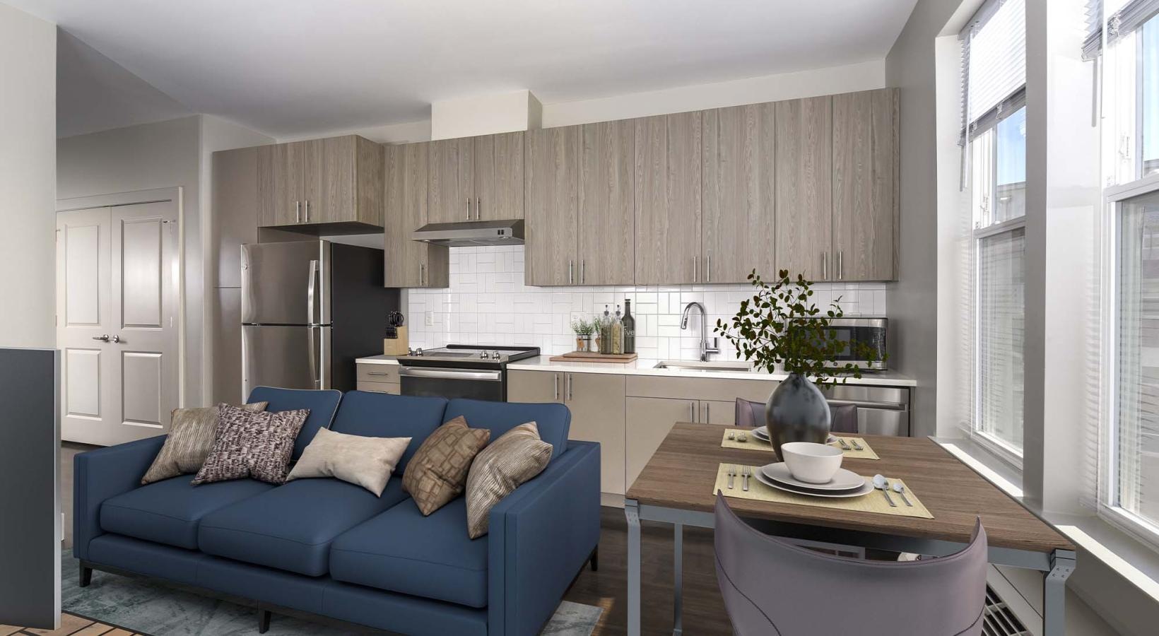 Beautiful living areas to match your lifestyle a kitchen and a living room with a blue couch