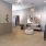 a clubroom with an elevator, couches and tables