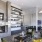 a clubroom with a fireplace, a couch, tables and chairs