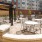 a group of tables and chairs outside