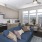 a kitchen and a living room with a blue couch