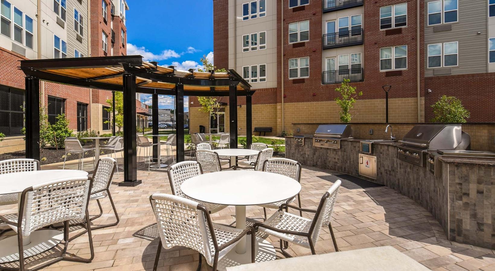 Access to resident-only features a patio with tables and chairs