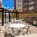 a patio with tables and chairs