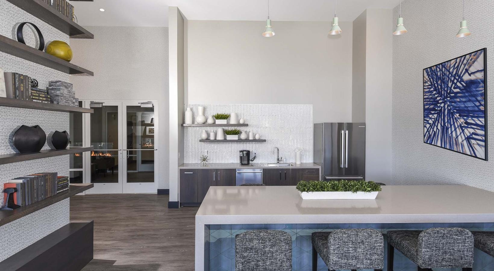 Enjoy our resident-only features a clubroom kitchen with a bar and chairs