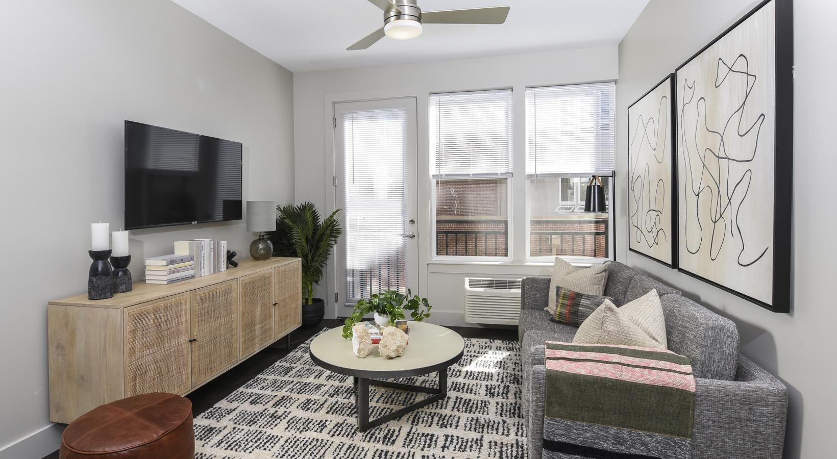 Generous living spaces with beautiful natural lighting a living room with a couch and a table