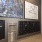 a mail center with black mail boxes and wall art