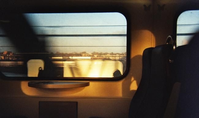 a view of a sunset through a window of a train